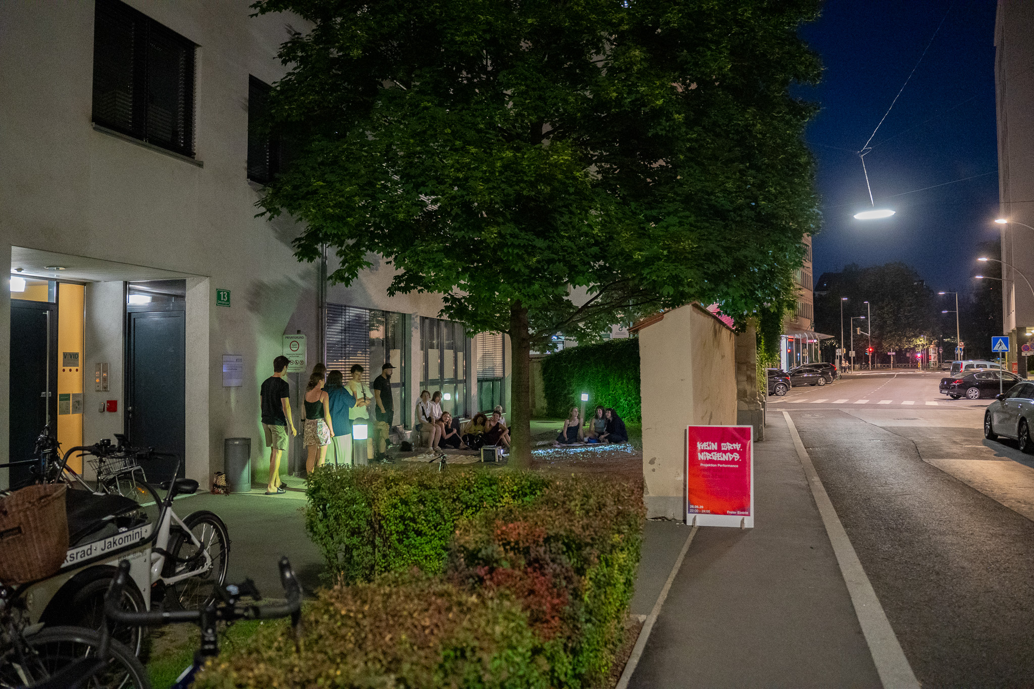 The site at night with the poster on the pavement