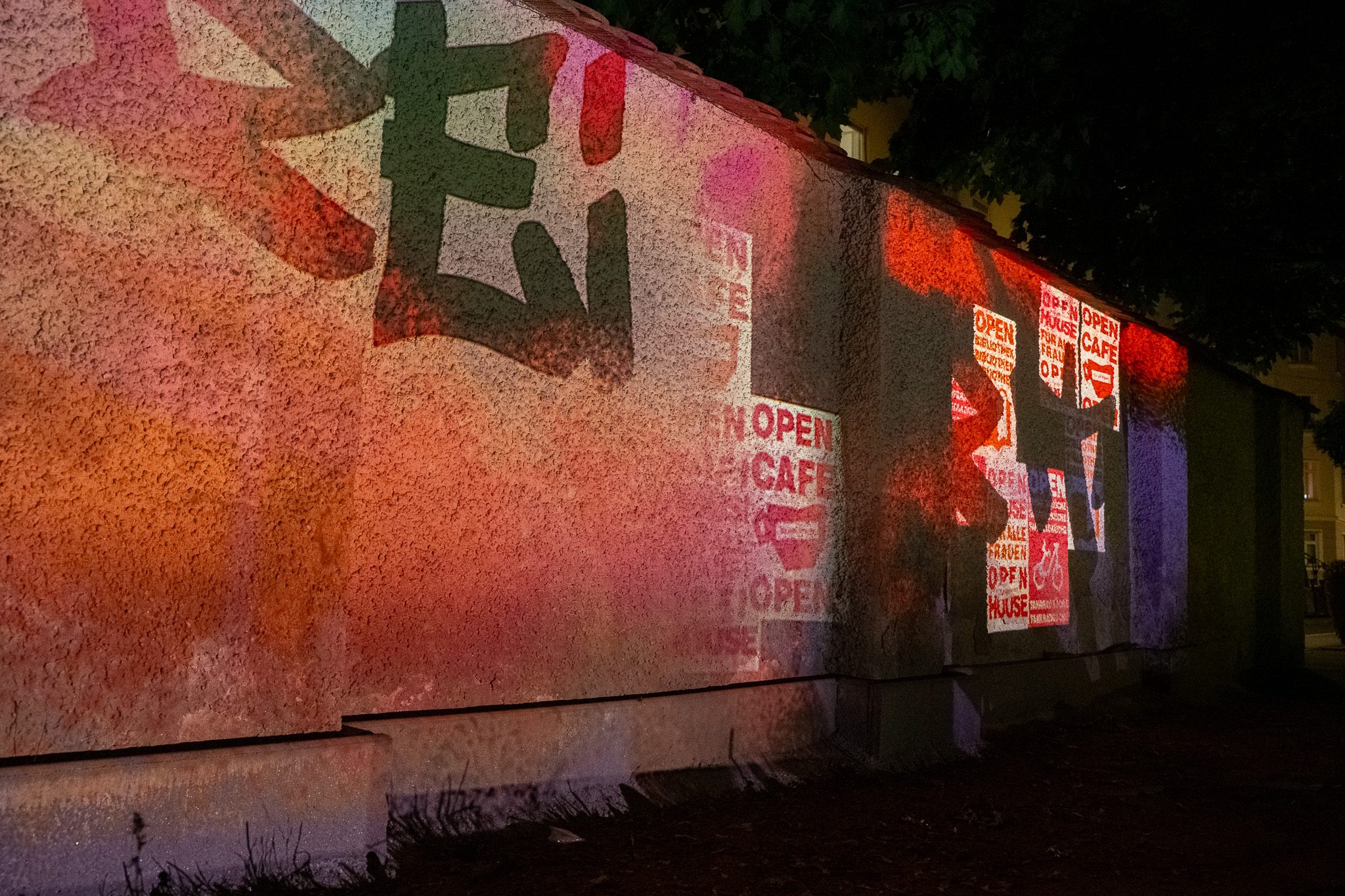 Projected posters on the plastered wall
