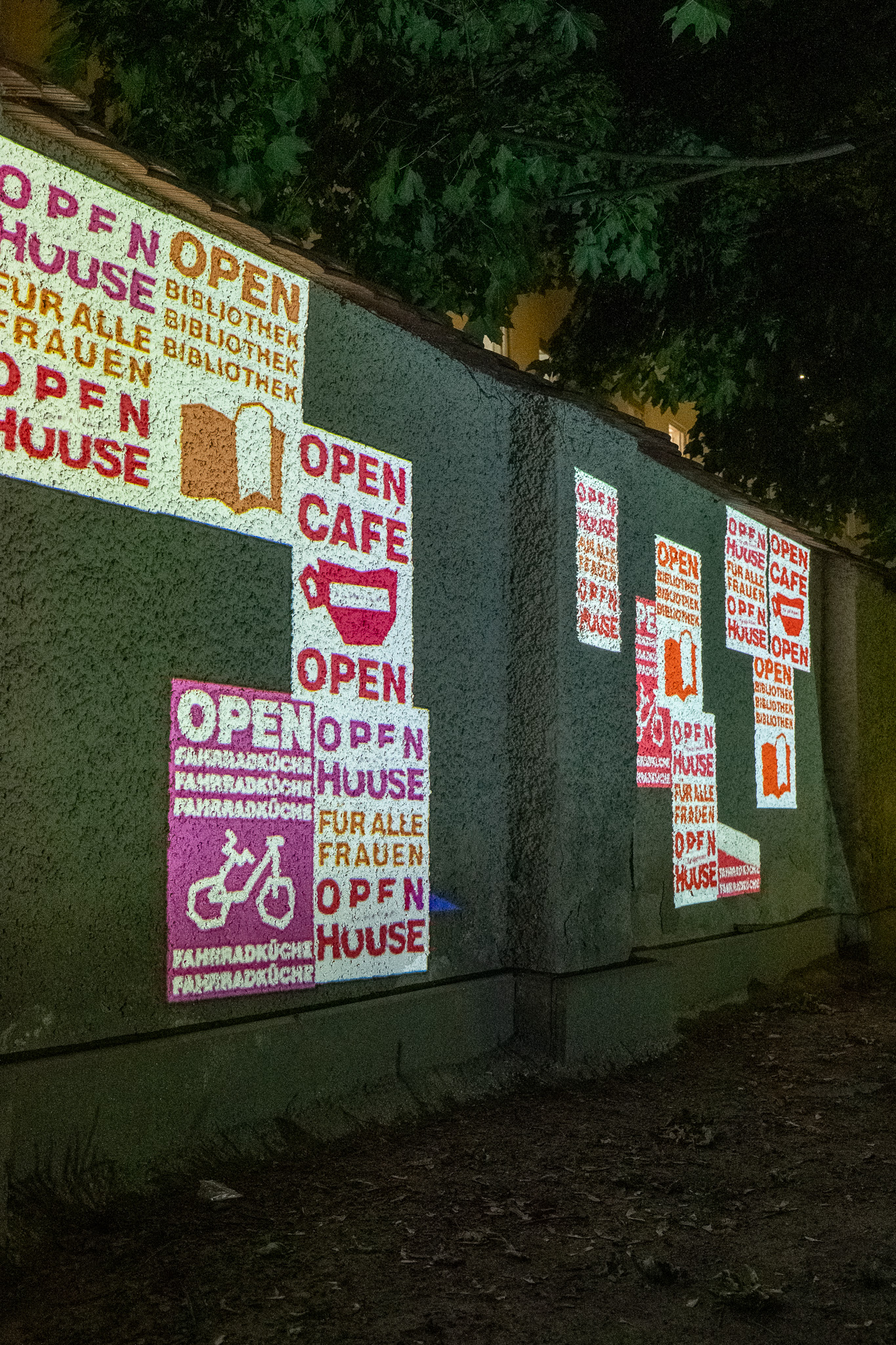 OPEN posters projected across the wall